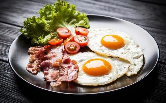 Two eggs on two eggs with bacon